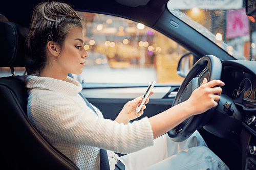 A young woman driving a car.