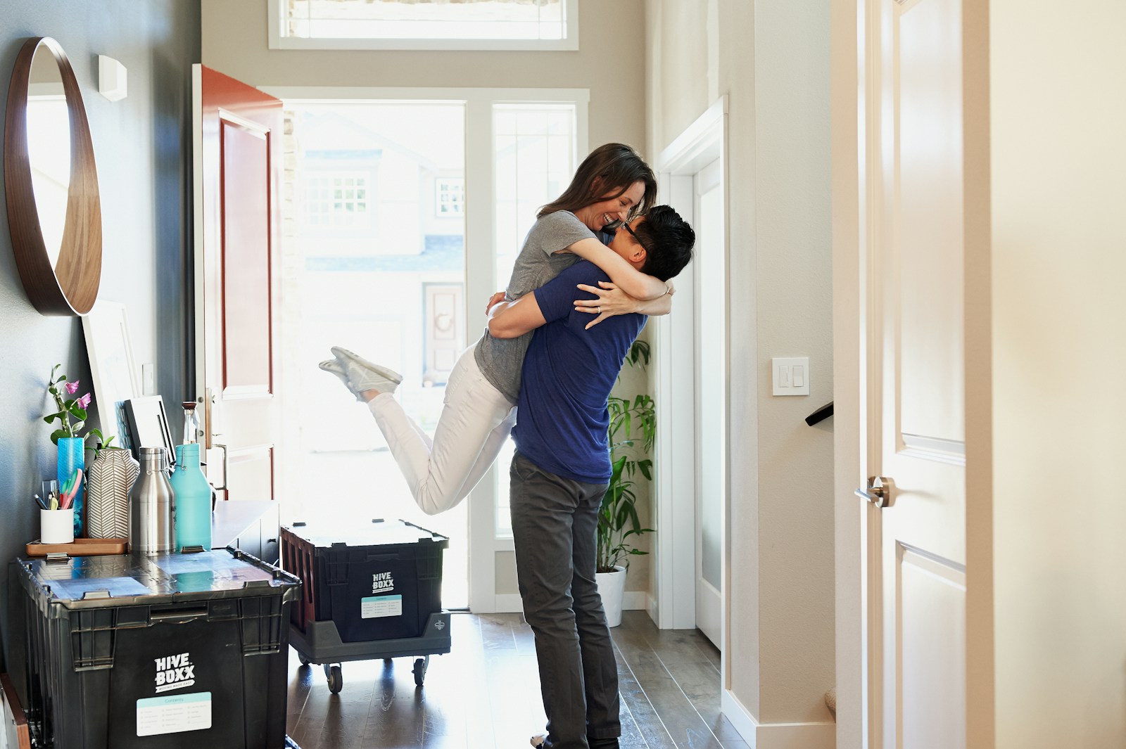 woman in gray long sleeve shirt and gray pants with renters insurance standing beside white wooden door