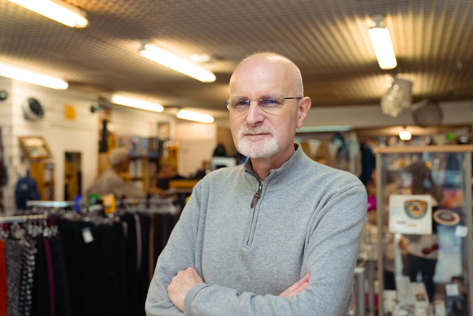 Bald man with glasses in a store